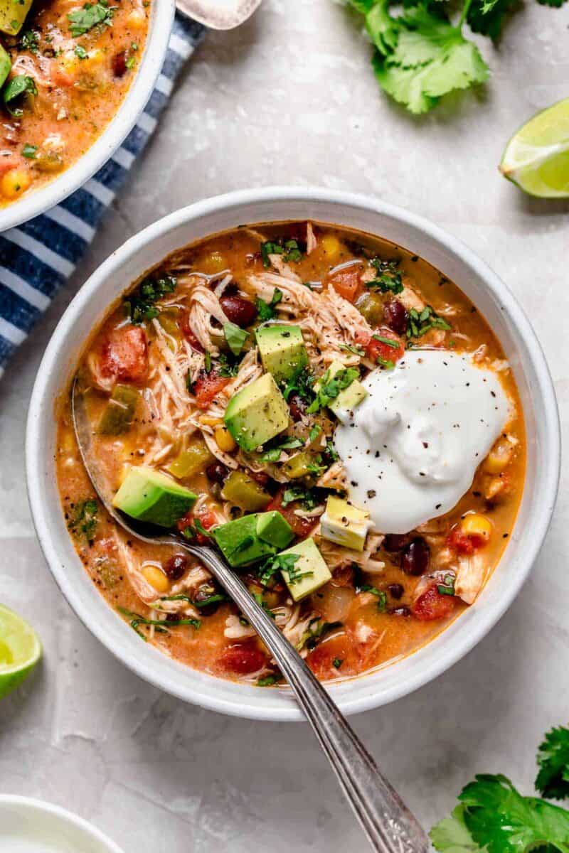 Slow cooker chicken enchilada soup is full of flavor and the perfect weeknight meal that takes no time at all to put together!