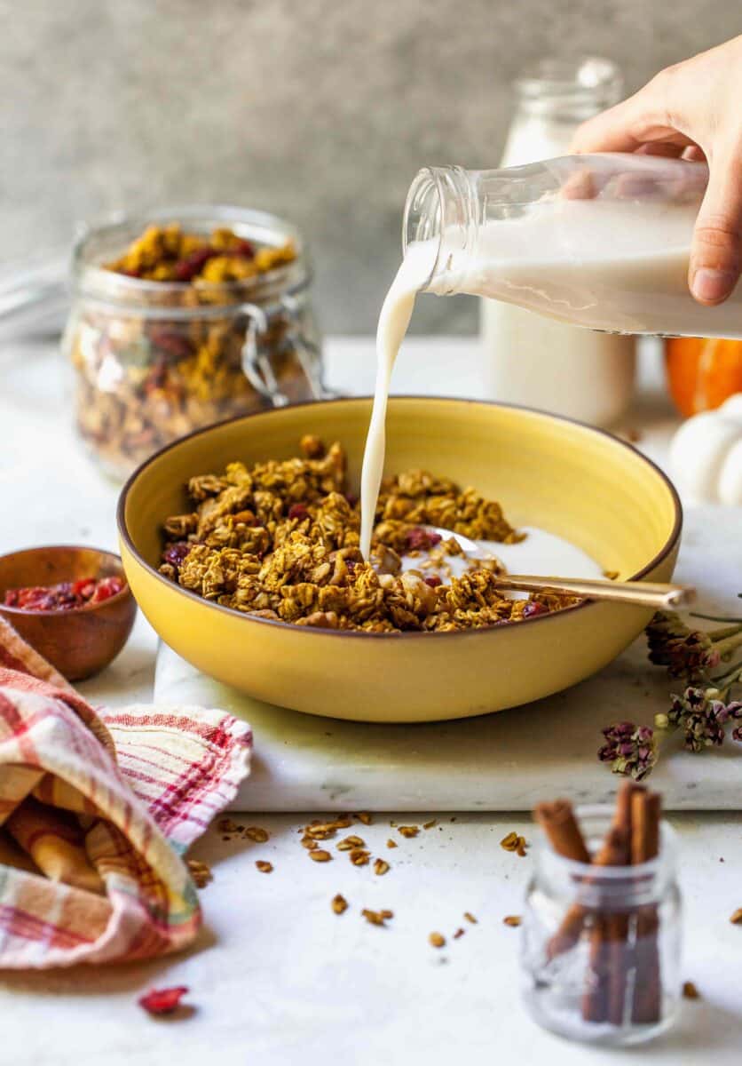 Pumpkin cranberry granola is a deliciously simple yet aromatic Fall treat! You'll want to eat it with almost everything!