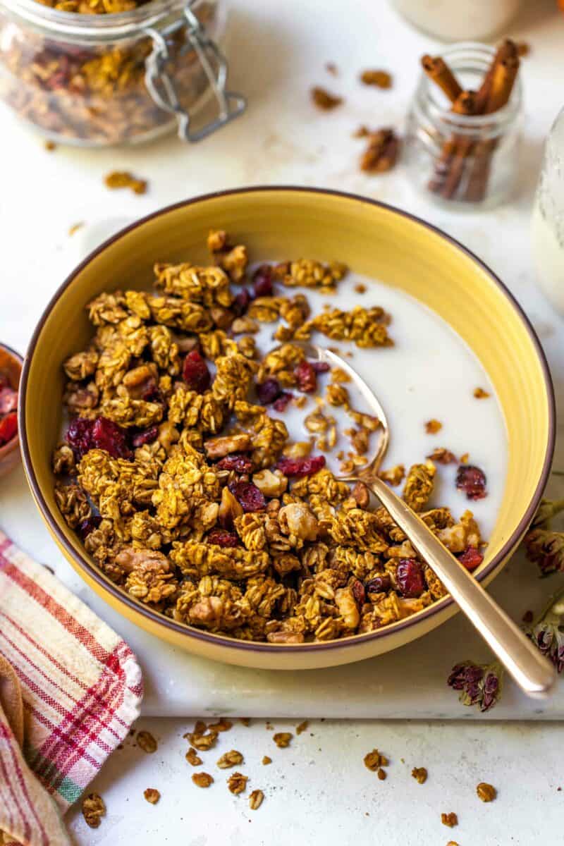 Pumpkin cranberry granola is a deliciously simple yet aromatic Fall treat! You'll want to eat it with almost everything!