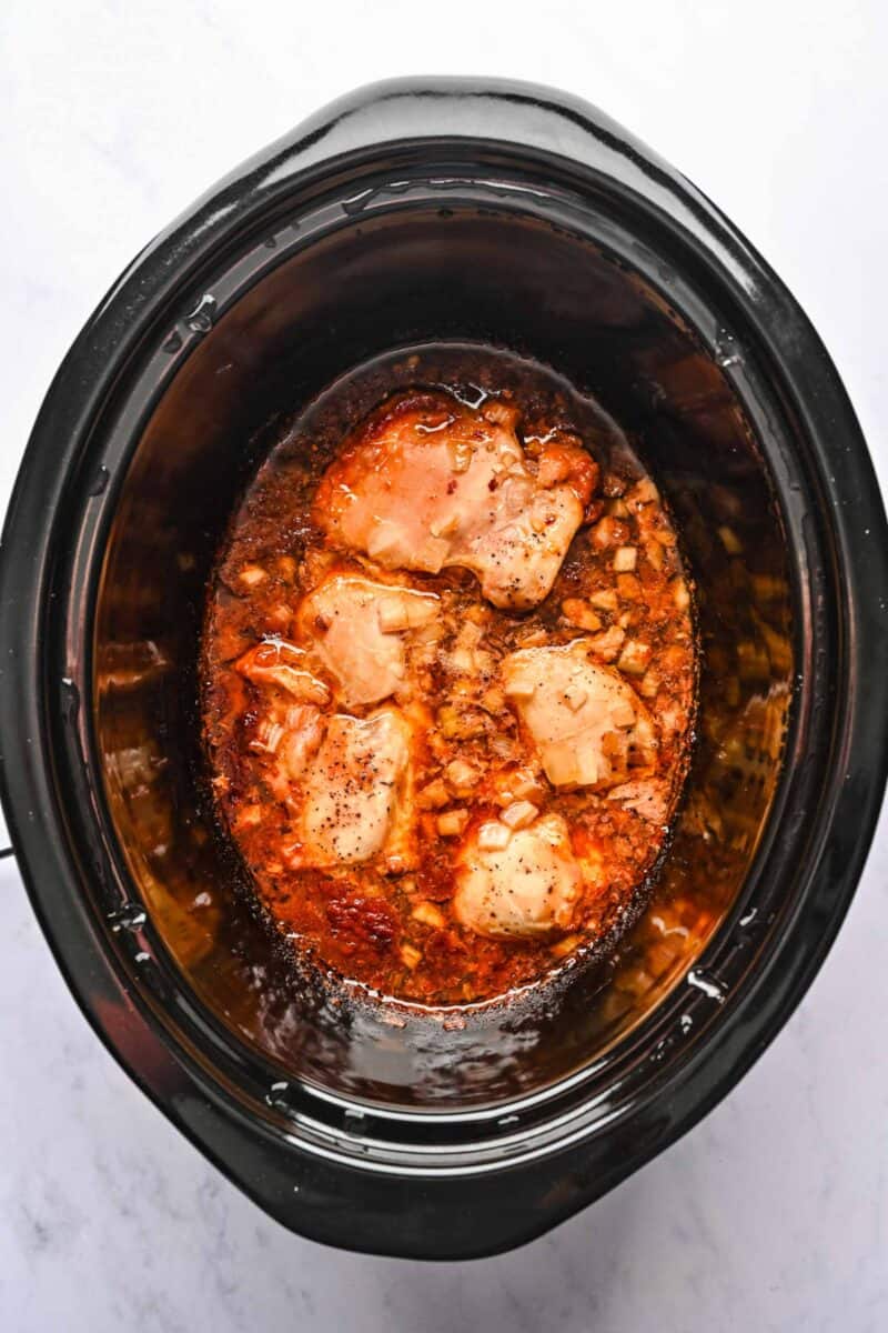 Cooked honey sesame chicken inside the crockpot.