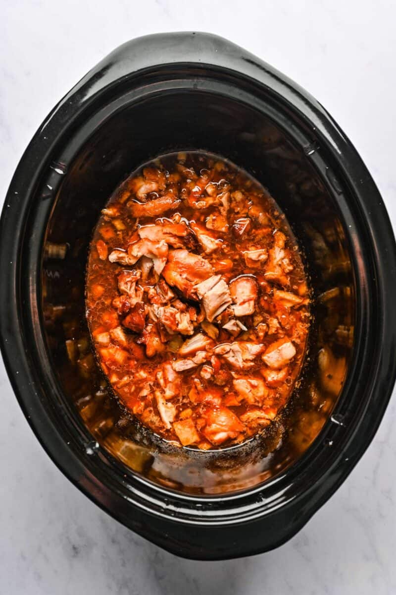 Chopped chicken pieces added back into the crockpot with honey sesame sauce.