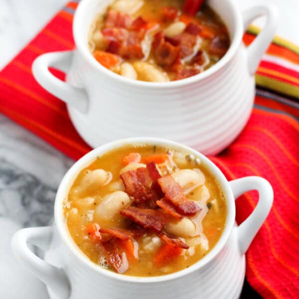 Creamy white bean and bacon soup will warm you right up! The flavors are INCREDIBLE - smokey, creamy, and so hearty!!