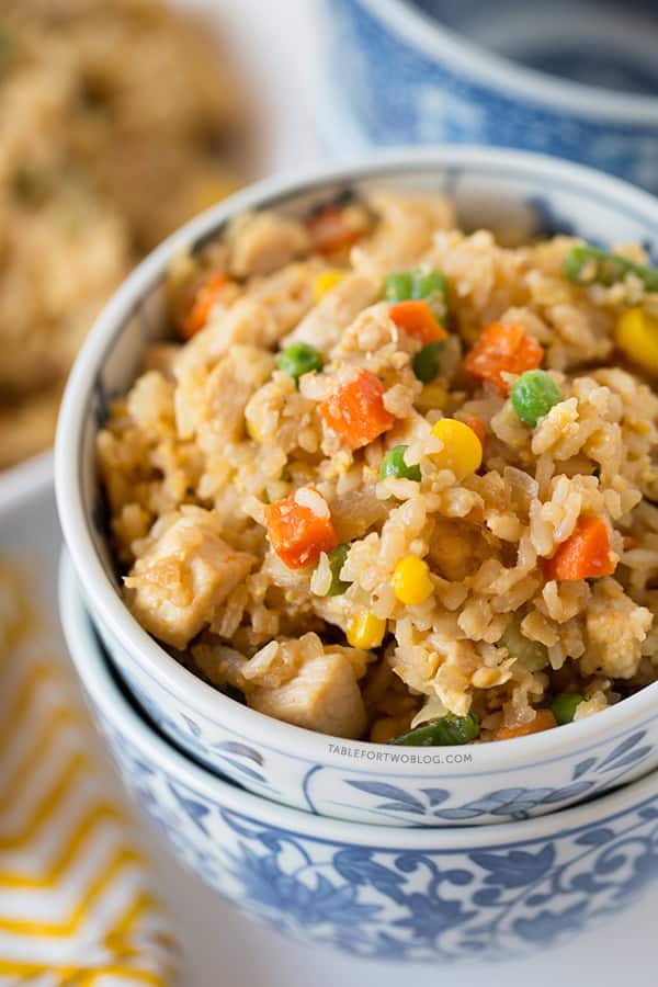 Take-out, fake-out chicken fried rice is so easy to whip up yourself that you won't need to call for take-out! Recipe on tablefortwoblog.com