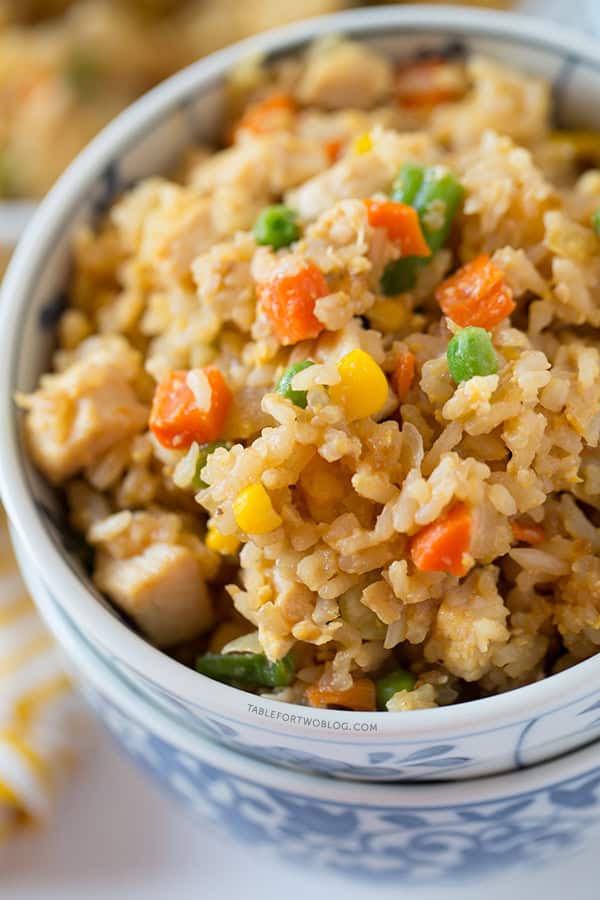 Take-out, fake-out chicken fried rice is so easy to whip up yourself that you won't need to call for take-out! Recipe on tablefortwoblog.com