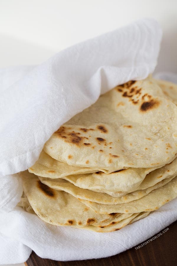 Homemade Flour Tortillas are way better than store-bought and so easy to make. Recipe on tablefortwoblog.com