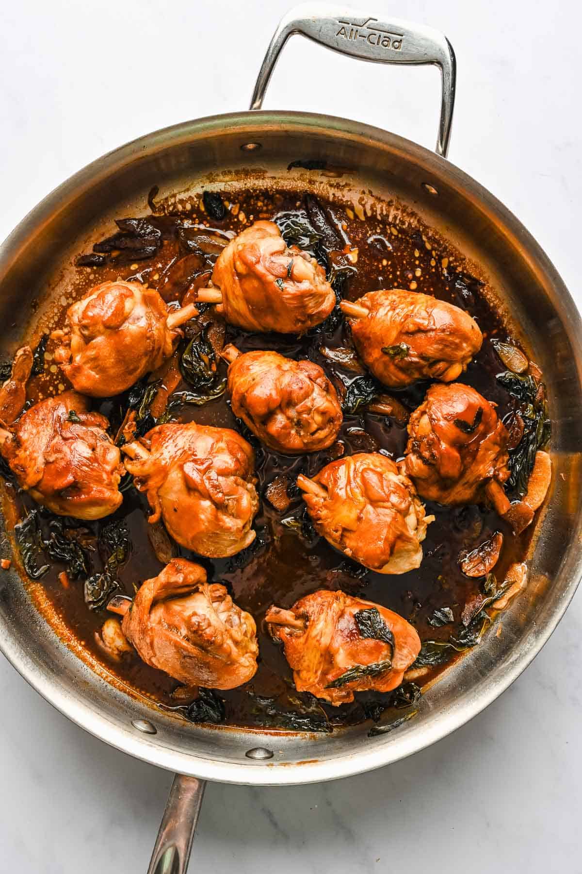 Three cup chicken in a skillet.