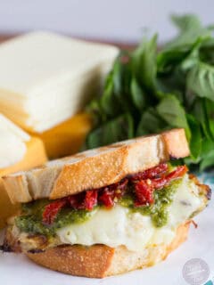 A bold and cheesy pesto chicken sandwich with sundried tomatoes!