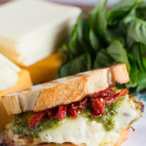 A bold and cheesy pesto chicken sandwich with sundried tomatoes!