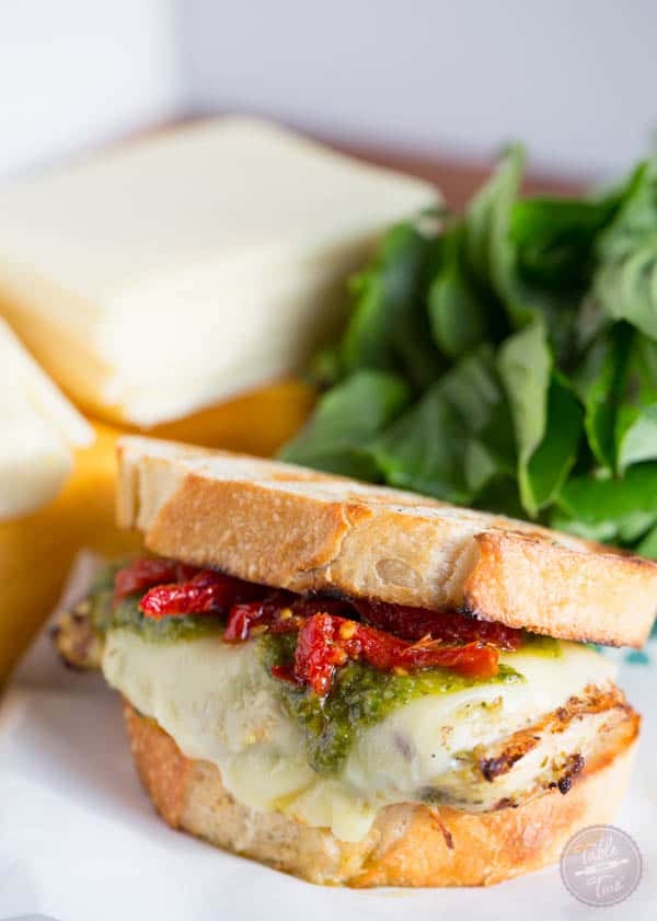 Turn on the grill & whip up this cheesy pesto chicken sandwich made with LAND O LAKES® Sharp Cheddar American Blend!