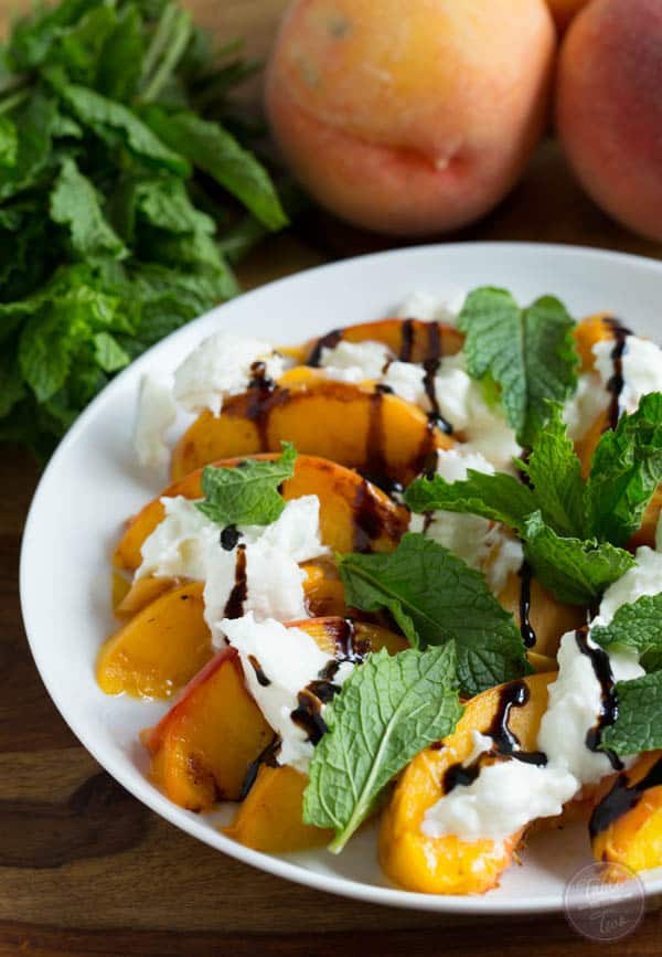 Grilled peaches with burrata, mint, and balsamic drizzle is a super easy summer appetizer that you'll want to have all summer long!