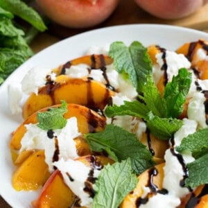 Grilled peaches with burrata, mint, and balsamic drizzle is a super easy summer appetizer that you'll want to have all summer long!