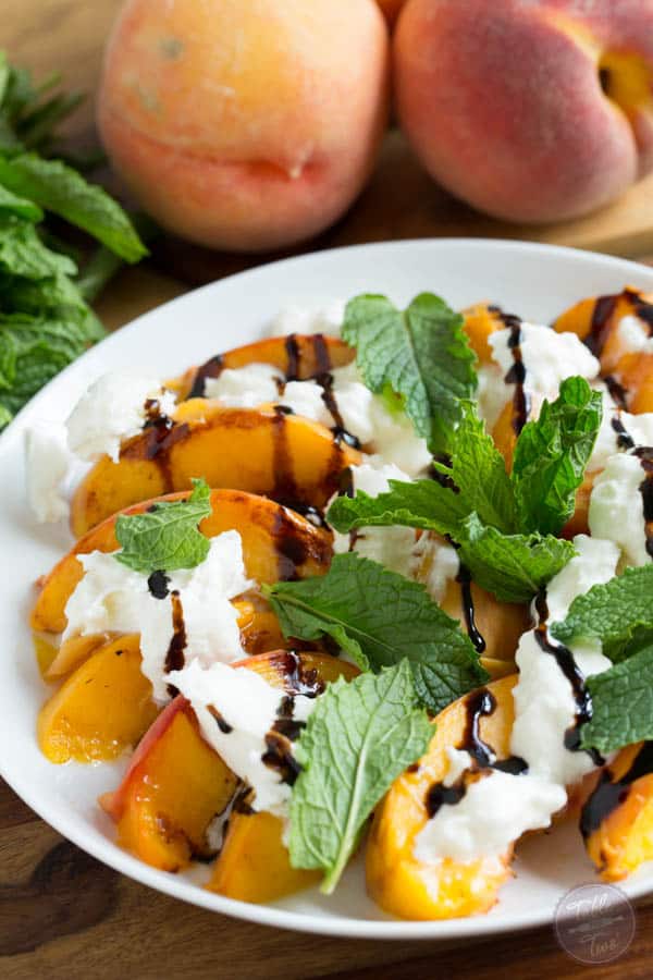 Grilled peaches with burrata, mint, and balsamic drizzle is a super easy summer appetizer that you'll want to have all summer long!