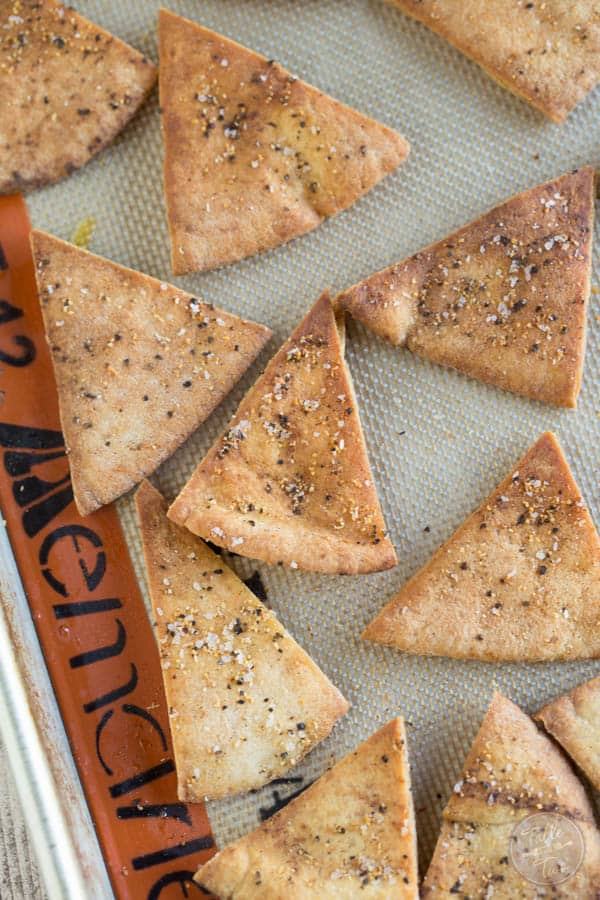 Homemade seasoned pita chips are so easy to make and perfect to pair with your favorite dip! Make these for your next game day or television binge day!