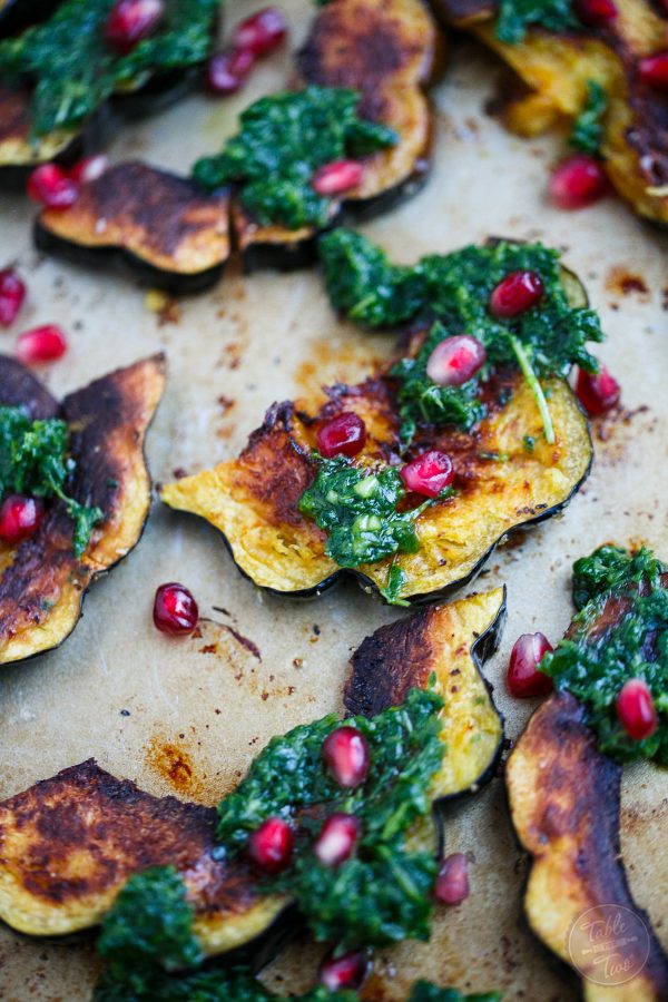 Roasted acorn squash with arugula pesto and pomegranate is a great side dish addition to any meal! You'll love how vibrant and colorful this side dish looks on your table!