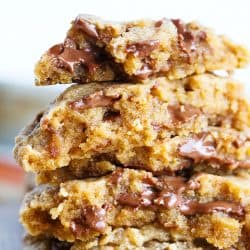 Peanut butter overload cookies are a peanut butter lovers' dream! Studded with Reese's peanut butter cups throughout, this cookie is so soft and perfect for all peanut butter and chocolate lovers!
