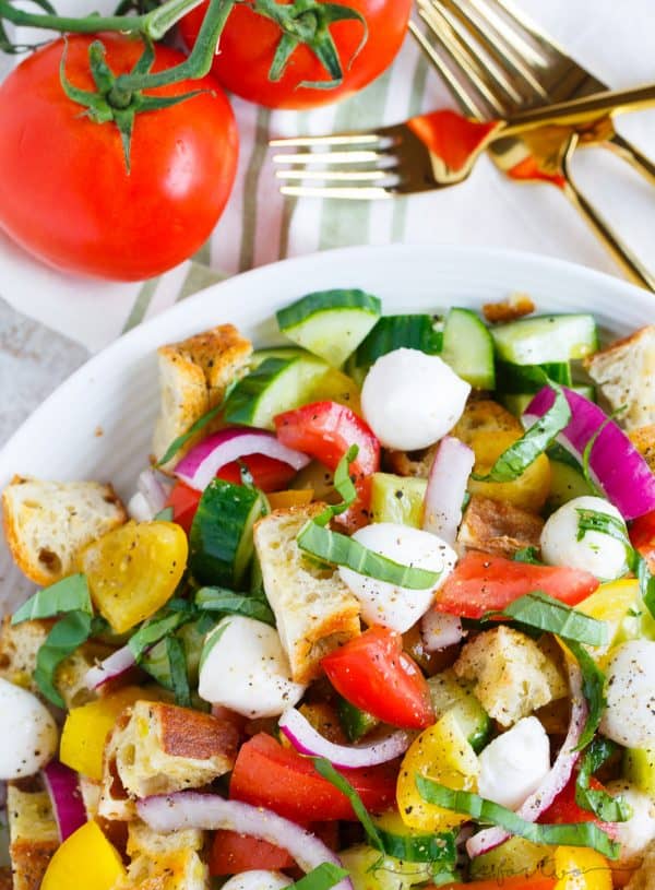 A delightfully light and refreshing summer panzanella salad for your dinner table! This is a great way to use up all the abundant summer produce and a great dinner side item or even as an entree!