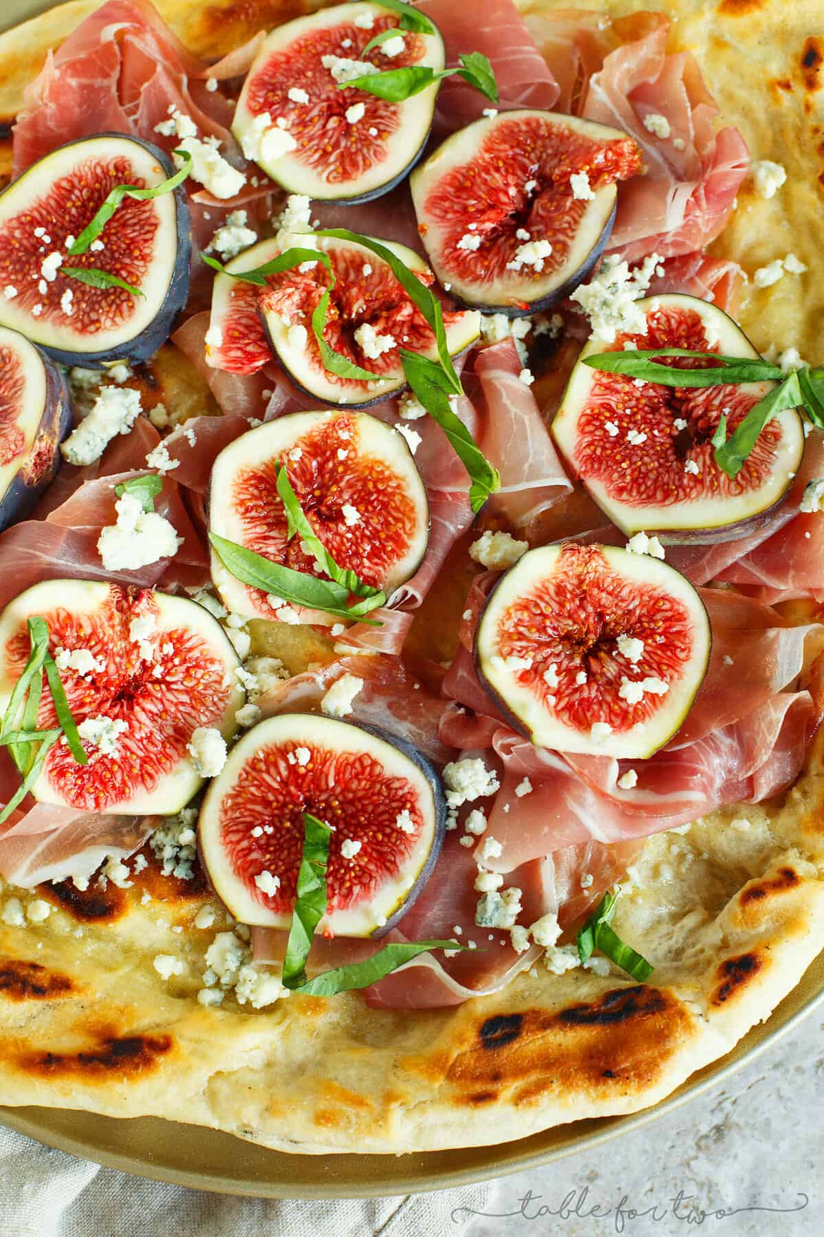 A classic combination of flavors but what better than to throw it on a grilled pizza? The pungent blue cheese pairs so well with the rest of the sweet figs and salty prosciutto!