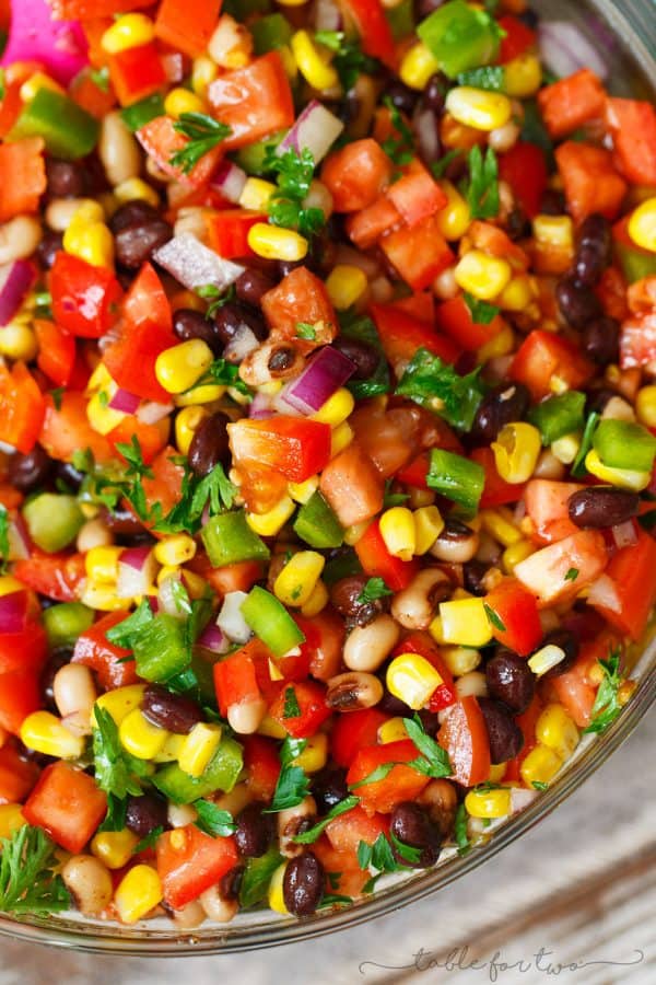 The most colorful salad you will have at your next party or barbecue! Cowboy caviar is like a mashup between salsa and beans. Salsa and beans had a baby and named it cowboy caviar because it's just so hearty and richly delicious!