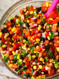 The most colorful salad you will have at your next party or barbecue! Cowboy caviar is like a mashup between salsa and beans. Salsa and beans had a baby and named it cowboy caviar because it's just so hearty and richly delicious!