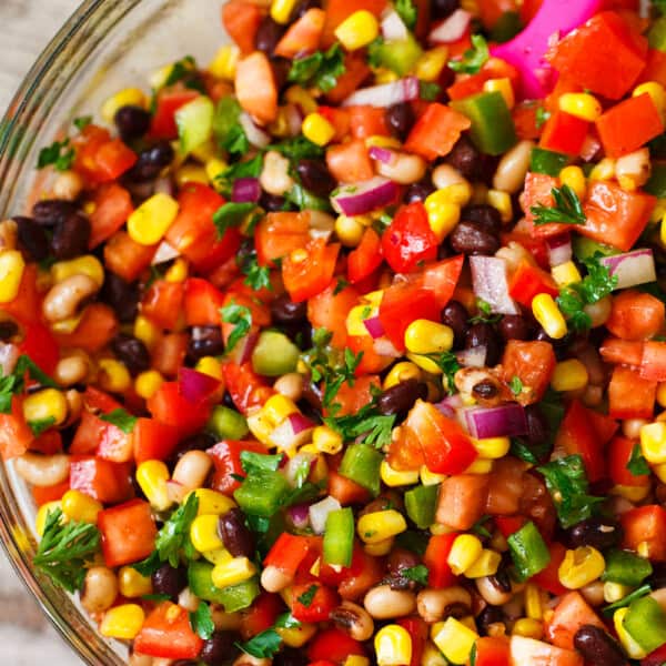 The most colorful salad you will have at your next party or barbecue! Cowboy caviar is like a mashup between salsa and beans. Salsa and beans had a baby and named it cowboy caviar because it's just so hearty and richly delicious!