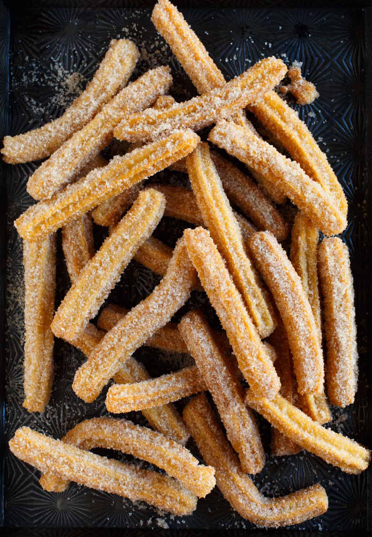 Mexican churros on black backdrop.