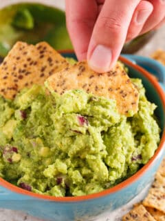 Everyone has to have a great guacamole recipe in their arsenal. Our favorite guacamole recipe is full of creaminess, tang, and bite! You will LOVE this version and always make batches of it to have on hand!