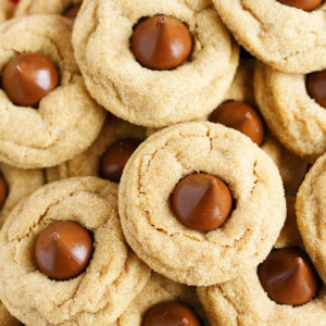 These classic peanut butter blossom cookies are a traditional holiday cookie around Christmas time! Soft and pillowy with a chocolate Hershey kiss in the center! You'll want to make a large batch as they are way too easy to eat and your family won't be able to keep their hands out of the cookie jar!