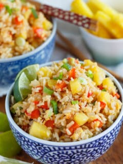 Take-out or take-in? You won't be able to tell that this pineapple fried rice was homemade and just as delicious as calling your neighborhood Thai takeout place! Much healthier to make this pineapple fried rice at home and it's super easy!