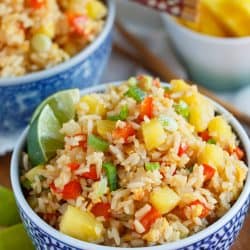 Take-out or take-in? You won't be able to tell that this pineapple fried rice was homemade and just as delicious as calling your neighborhood Thai takeout place! Much healthier to make this pineapple fried rice at home and it's super easy!