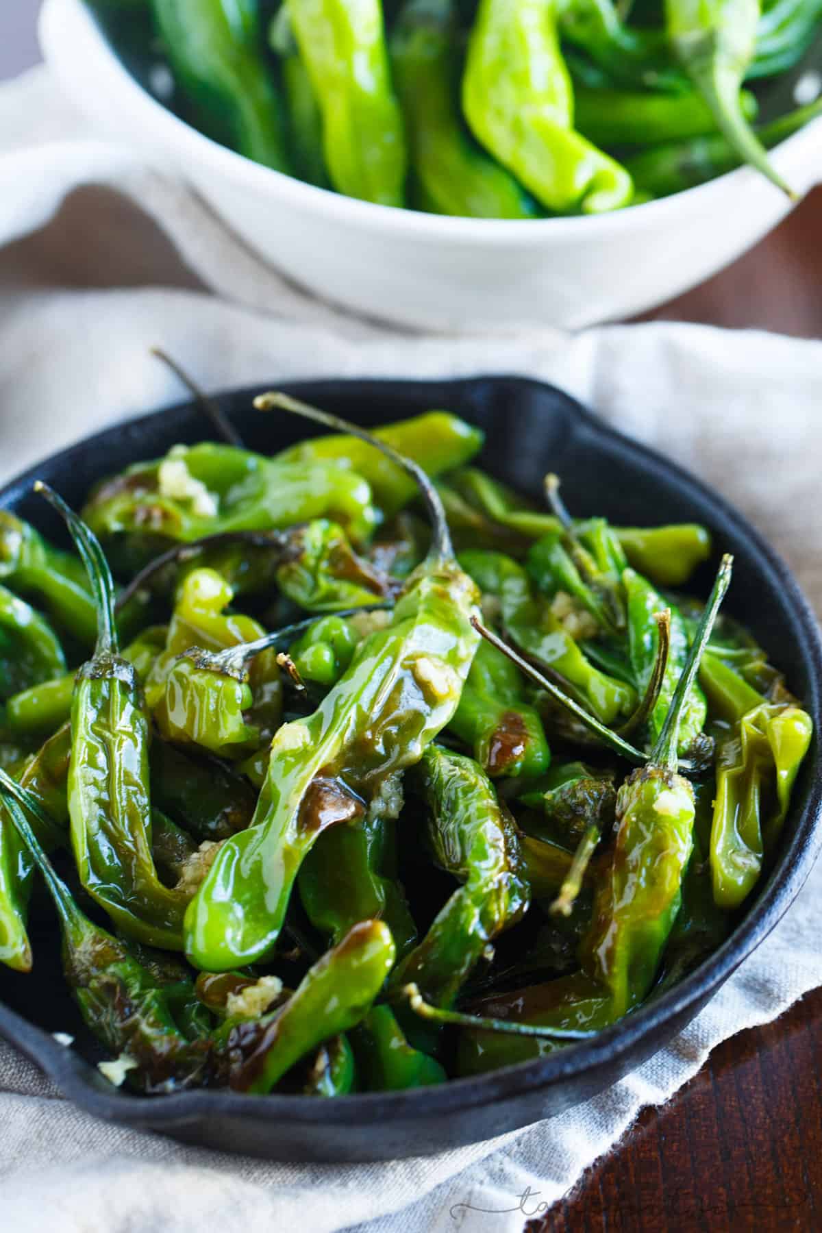 Blistered shishito peppers tossed in garlic and olive oil make for a great snack if you're feeling a little heat!