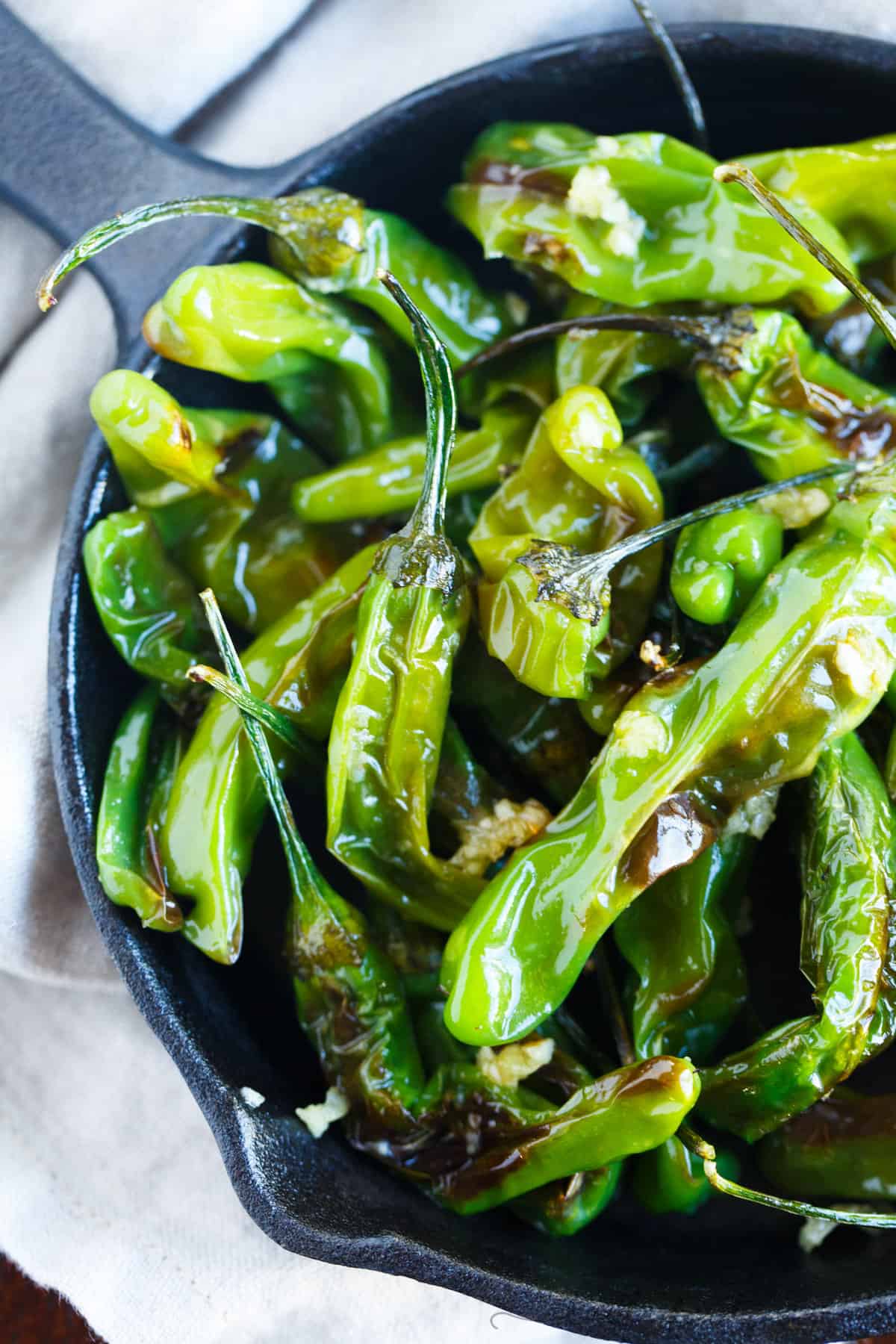 Blistered shishito peppers tossed in garlic and olive oil make for a great snack if you're feeling a little heat!