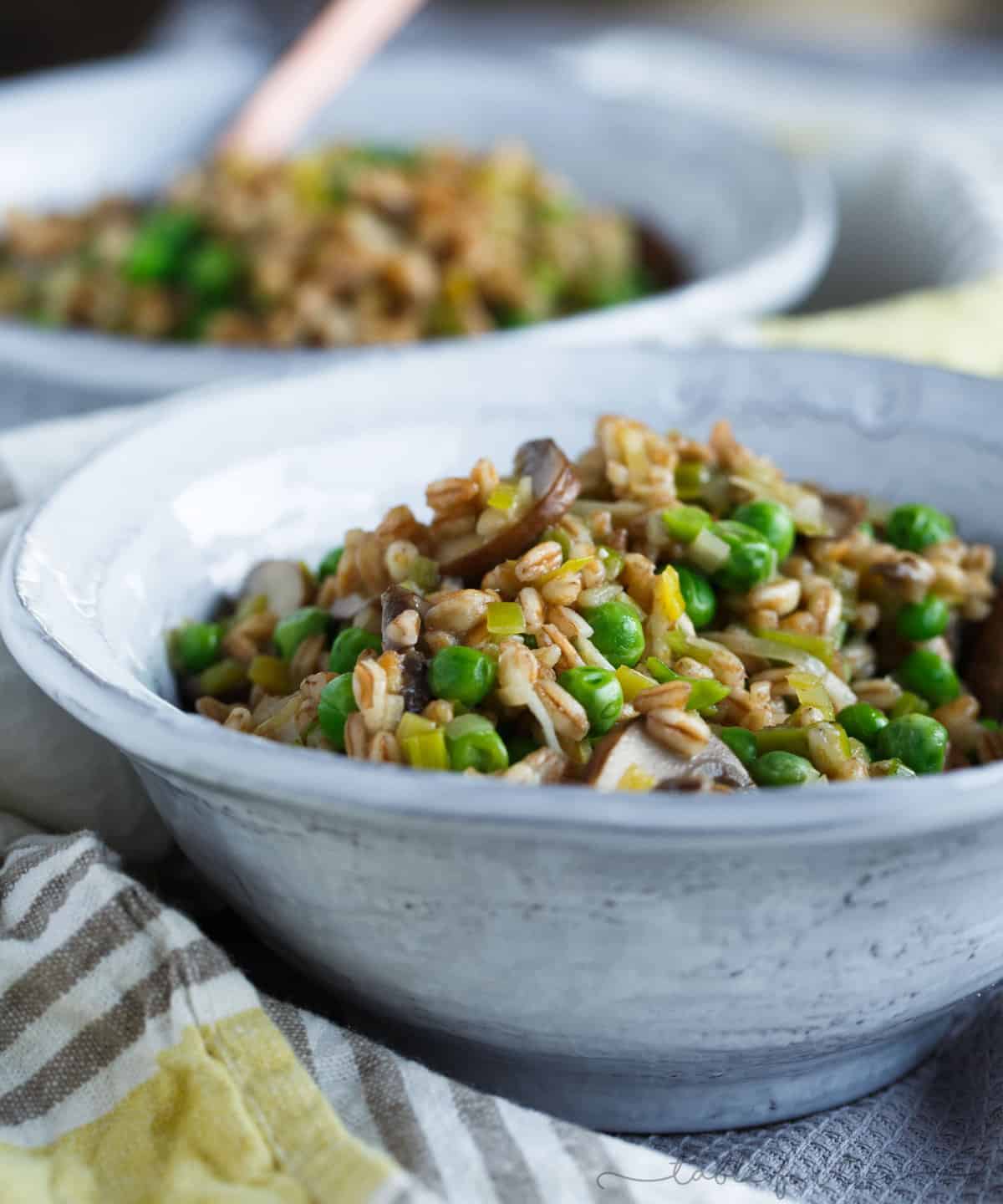 A great way to use farro in this flavorful dish! Filled with leeks, mushrooms, peas, and lots of parmesan cheese; this cozy farro dish is a quick one to whip up anytime of the week!