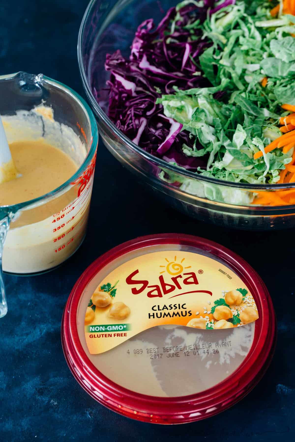 This cabbage slaw is a crisp and refreshing side dish for your next gathering! The creamy hummus dressing made with @sabradips classic hummus is going to be one of your new favorites to drizzle on everything! #ad