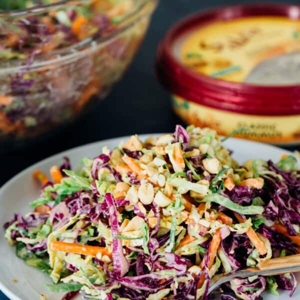 This cabbage slaw is a crisp and refreshing side dish for your next gathering! The creamy hummus dressing made with @sabradips classic hummus is going to be one of your new favorites to drizzle on everything! #ad