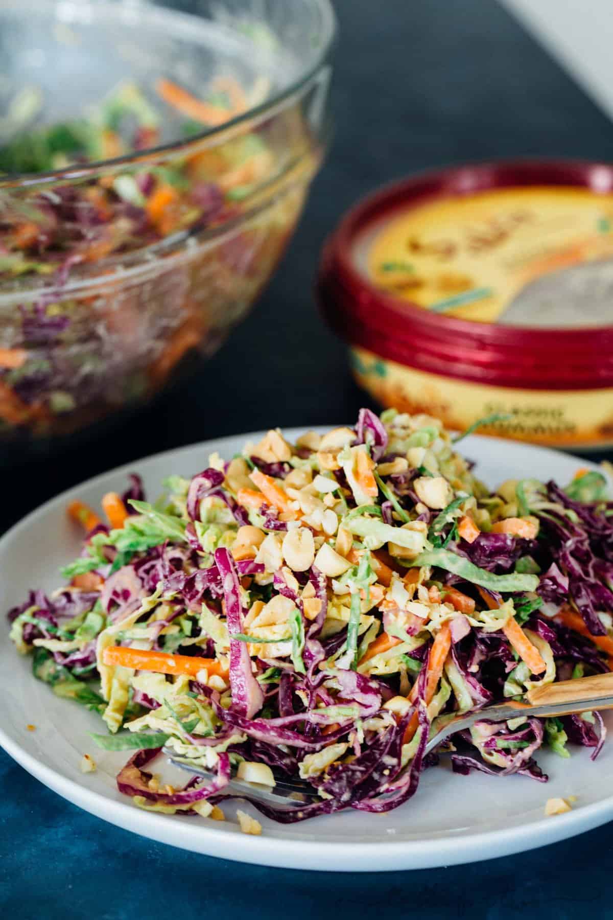 This cabbage slaw is a crisp and refreshing side dish for your next gathering! The creamy hummus dressing made with @sabradips classic hummus is going to be one of your new favorites to drizzle on everything! #ad