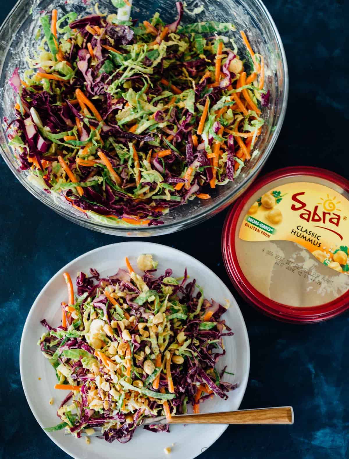 This cabbage slaw is a crisp and refreshing side dish for your next gathering! The creamy hummus dressing made with @sabradips classic hummus is going to be one of your new favorites to drizzle on everything! #ad