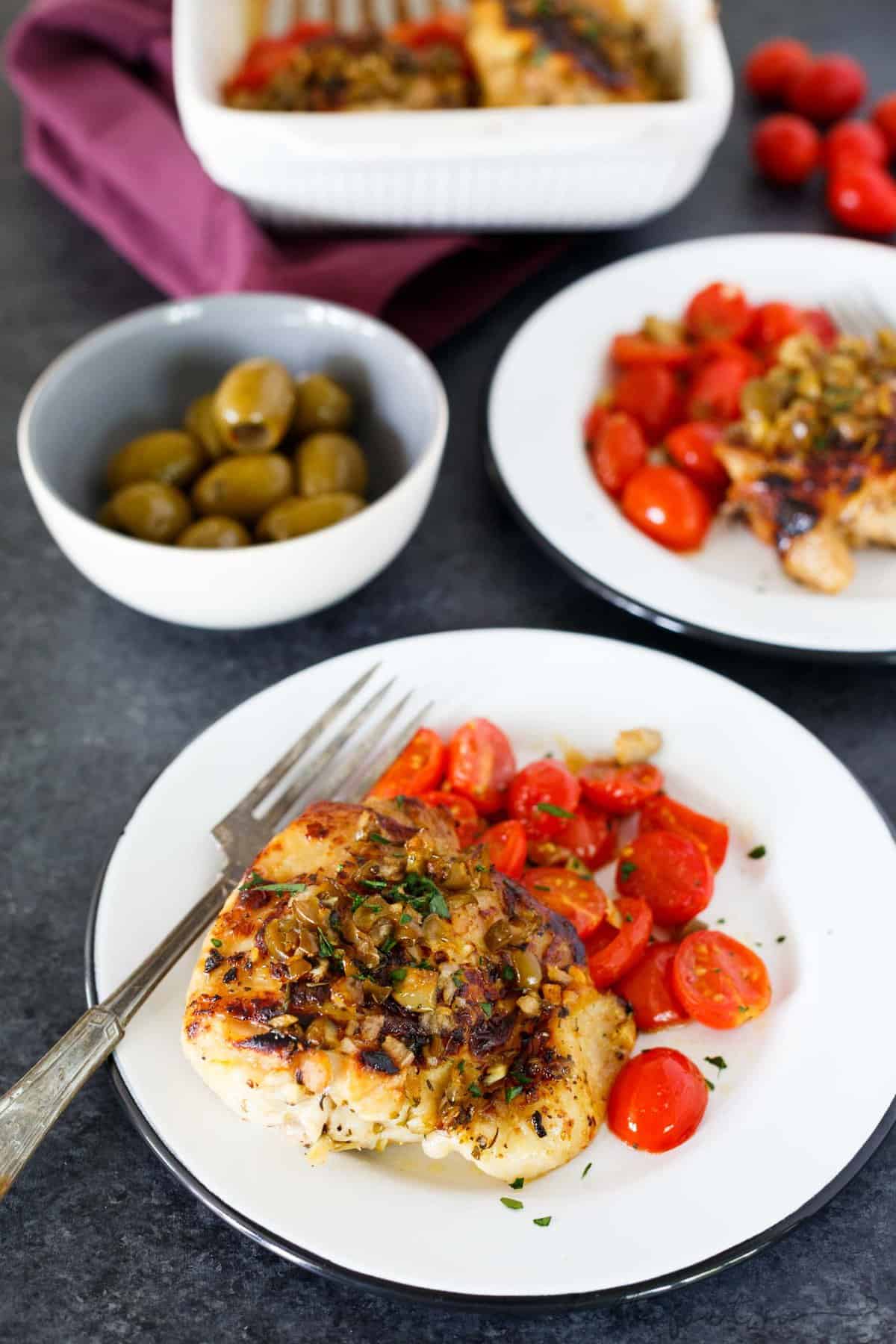 This oven-roasted chicken with olives and tomatoes is a deliciously flavorful weeknight dish. If you love briney and sweet; this roasted chicken is going to be your new favorite. The marinade is packed with flavor and is the perfect compliment to chicken!