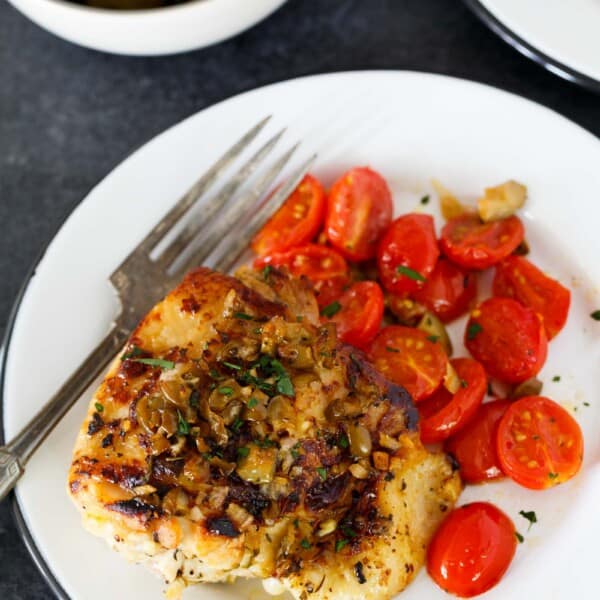 This oven-roasted chicken with olives and tomatoes is a deliciously flavorful weeknight dish. If you love briney and sweet; this roasted chicken is going to be your new favorite. The marinade is packed with flavor and is the perfect compliment to chicken!