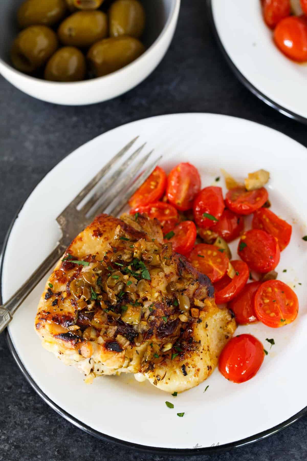 This oven-roasted chicken with olives and tomatoes is a deliciously flavorful weeknight dish. If you love briney and sweet; this roasted chicken is going to be your new favorite. The marinade is packed with flavor and is the perfect compliment to chicken!