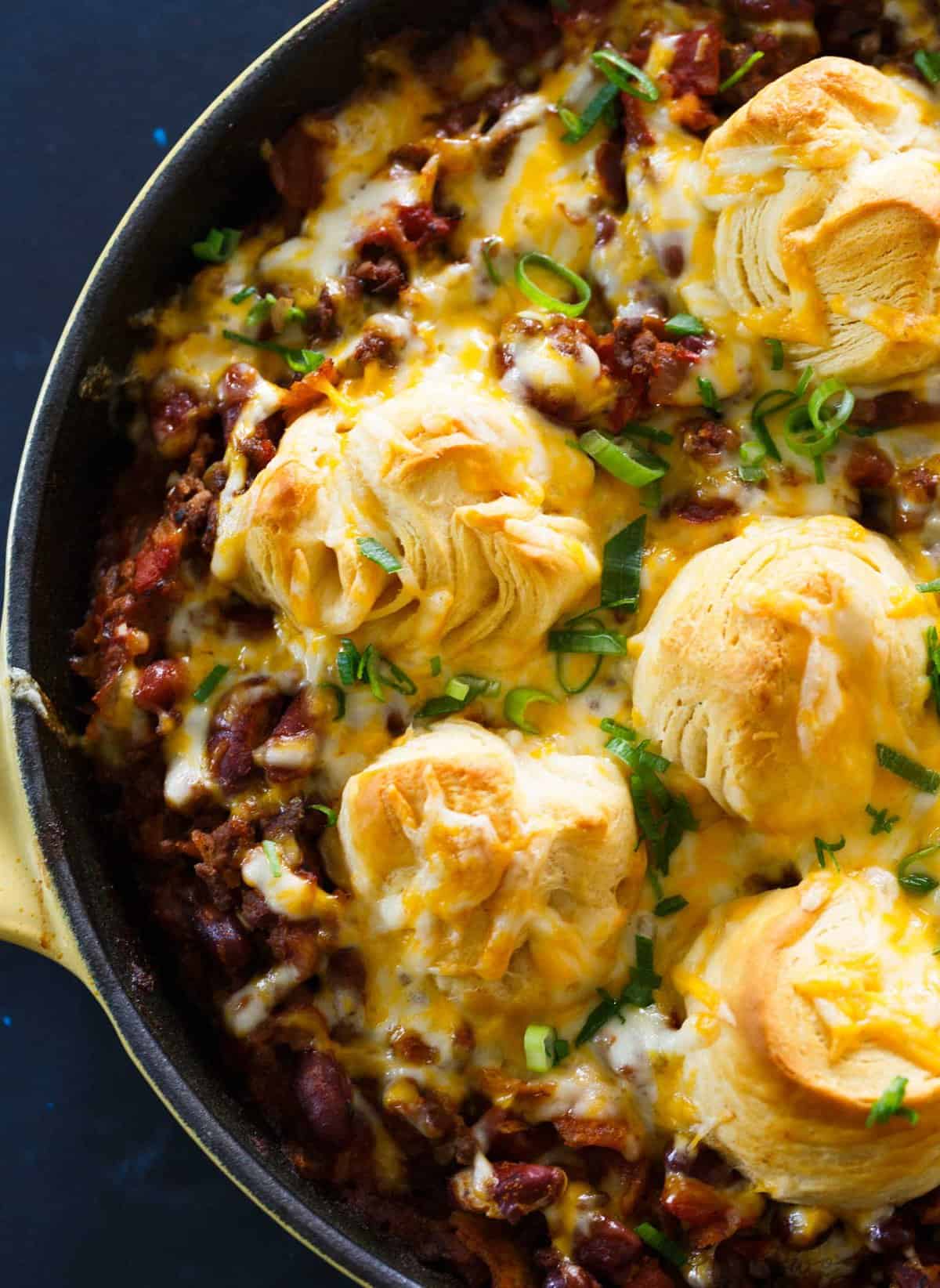 Pure comfort food is right here. Frito pie chili biscuit skillet has your name written all over it if you are looking for something that will stick to your ribs! Chili topped with fritos, cheese, and biscuits — what more could you ask for?!