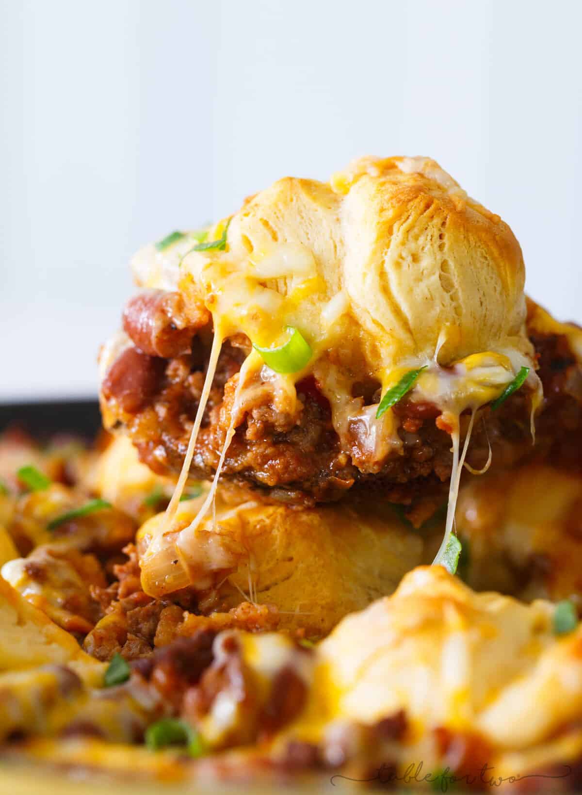 Pure comfort food is right here. Frito pie chili biscuit skillet has your name written all over it if you are looking for something that will stick to your ribs! Chili topped with fritos, cheese, and biscuits — what more could you ask for?!