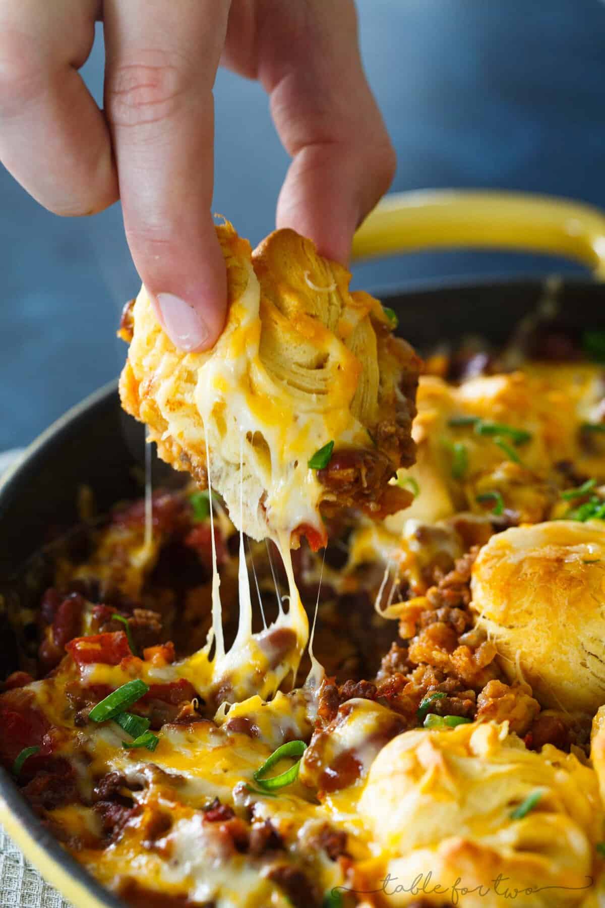 Pure comfort food is right here. Frito pie chili biscuit skillet has your name written all over it if you are looking for something that will stick to your ribs! Chili topped with fritos, cheese, and biscuits — what more could you ask for?!