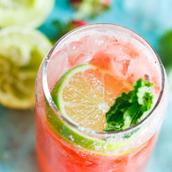 This refreshing strawberry rosé mint limeade is made with fresh seasonal ingredients! You will love sipping on this at your next outdoor party or get-together! Fresh strawberries are key and the refreshing mint and tangy lime juice rounds out the flavors of this drink perfectly! Serve with or without alcohol!