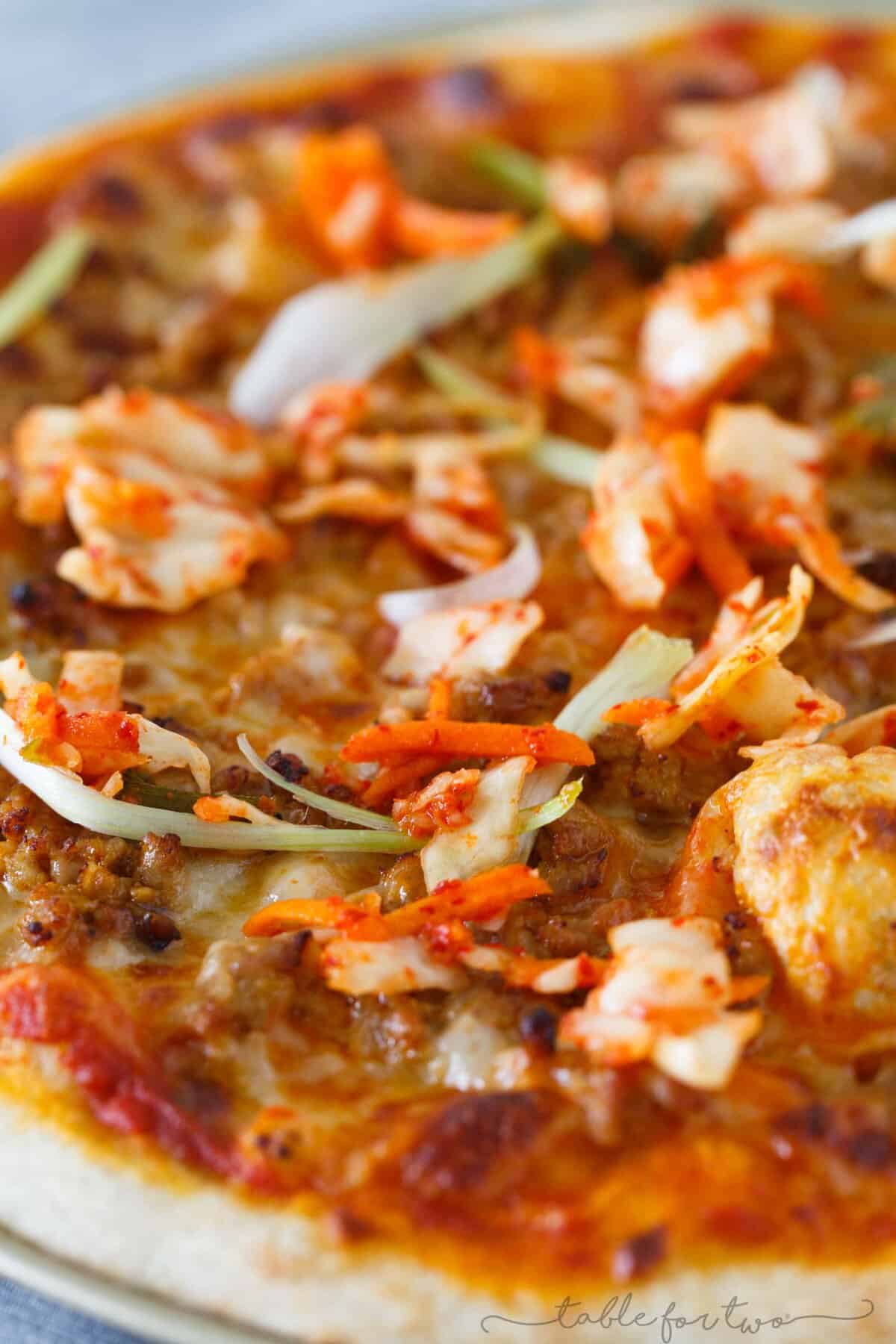 Italy meets Korea in this unique spicy Korean pork pizza recipe! This is a completely fun new way to make and eat pizza if you are a fan of Korean and Asian flavors! The flavors are so bold and perfectly balanced!