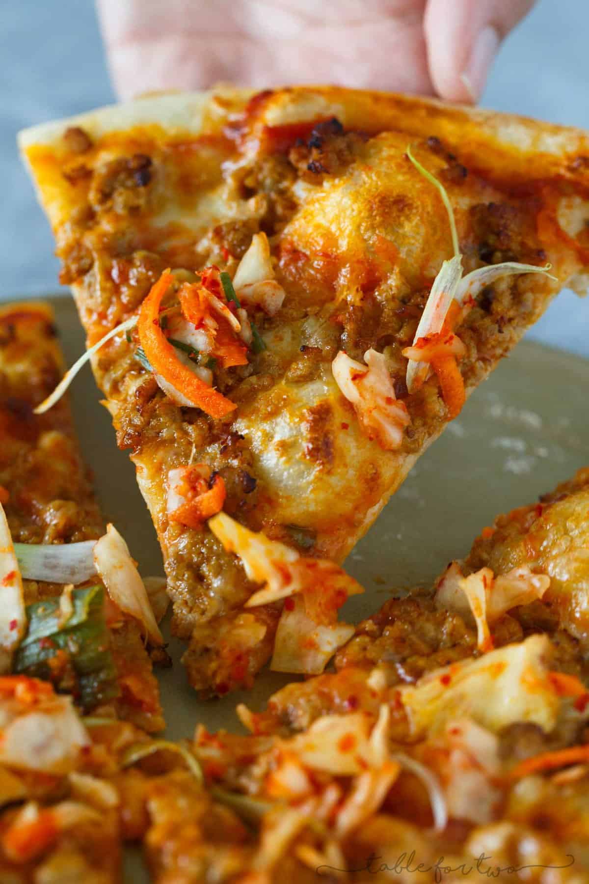 Italy meets Korea in this unique spicy Korean pork pizza recipe! This is a completely fun new way to make and eat pizza if you are a fan of Korean and Asian flavors! The flavors are so bold and perfectly balanced!