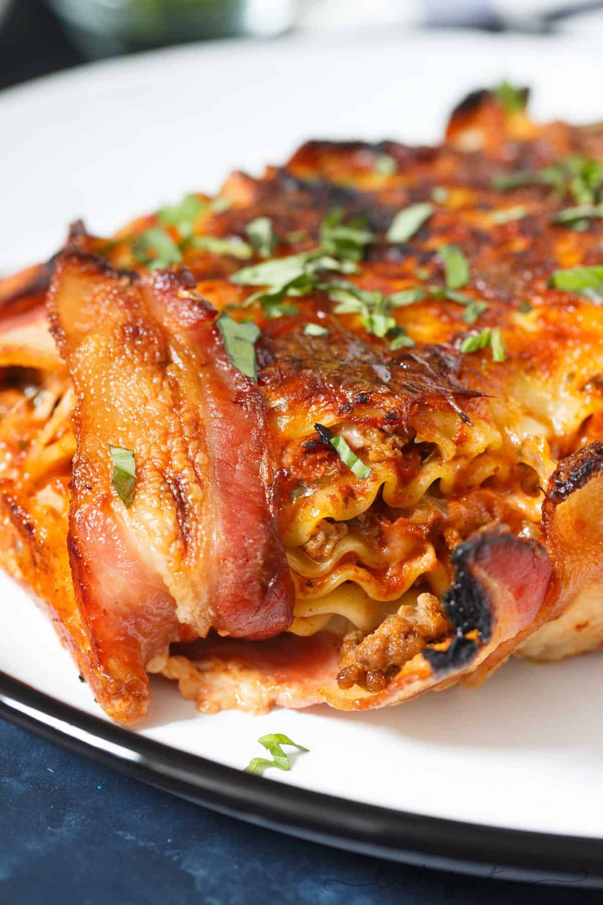 Who could say no to bacon wrapped lasagna? Once you have a bite of this, you will won't want to make lasagna any other way! This is such an awesome, decadent spin on the classic and traditional lasagna!