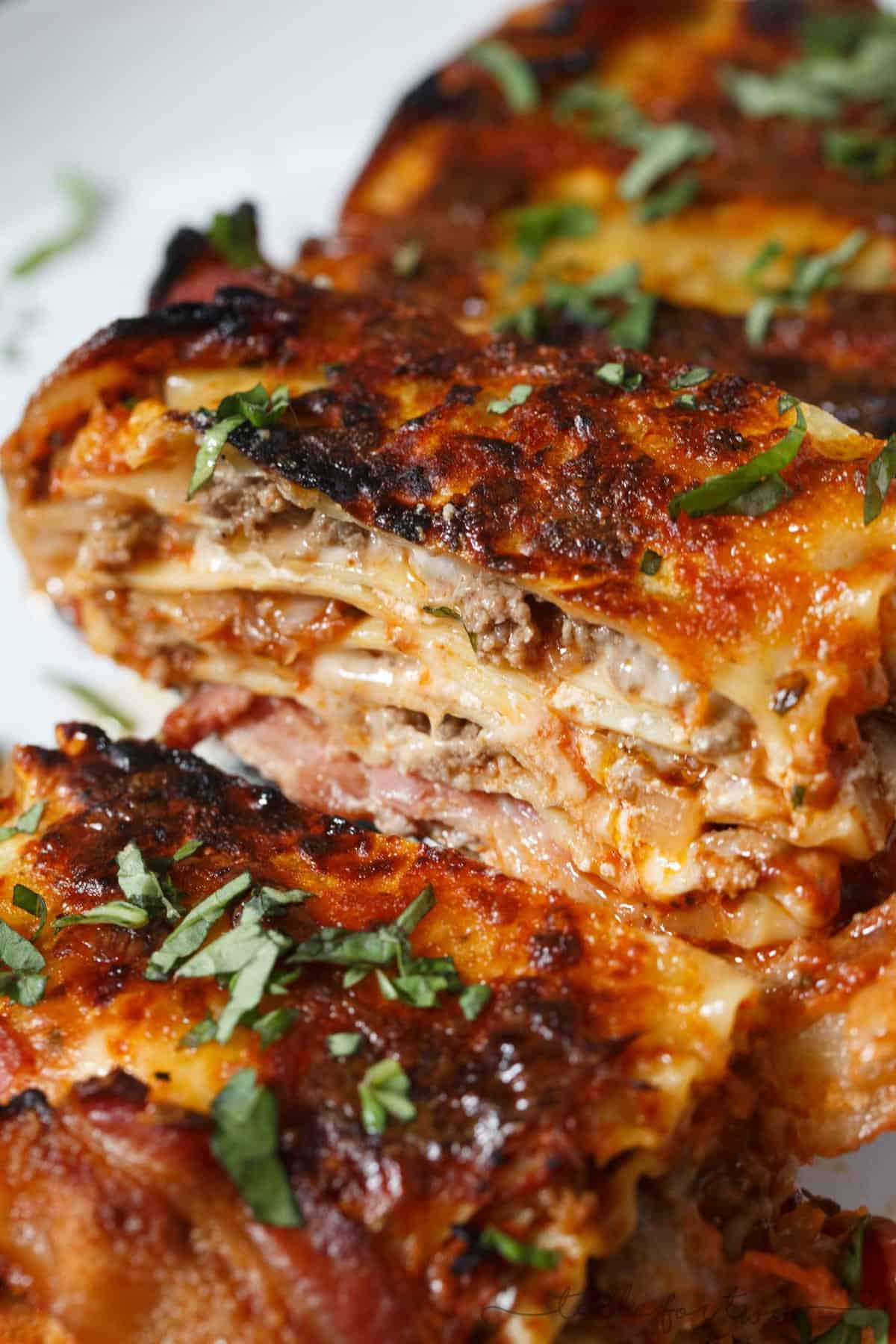 Who could say no to bacon wrapped lasagna? Once you have a bite of this, you will won't want to make lasagna any other way! This is such an awesome, decadent spin on the classic and traditional lasagna!