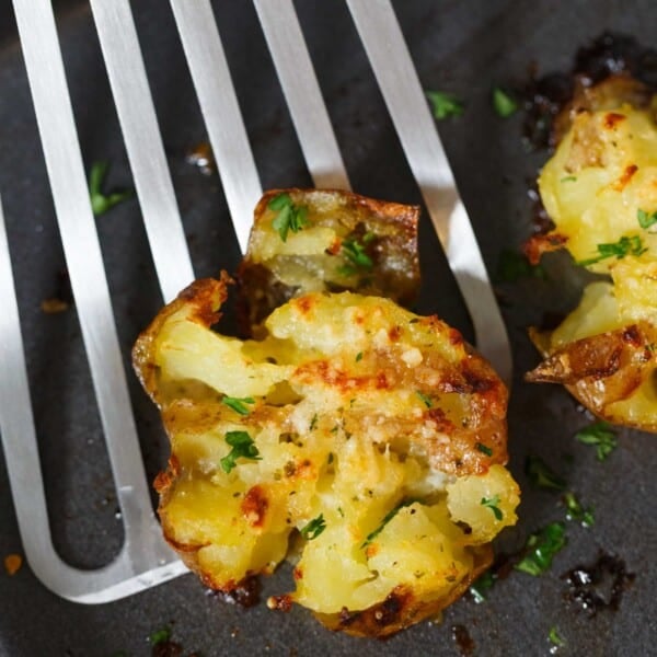 Smashed potatoes are a great alternative to mashed potatoes! These smashed potatoes are topped with a garlic ranch butter then parmesan cheese is sprinkled on top! SO GOOD!!