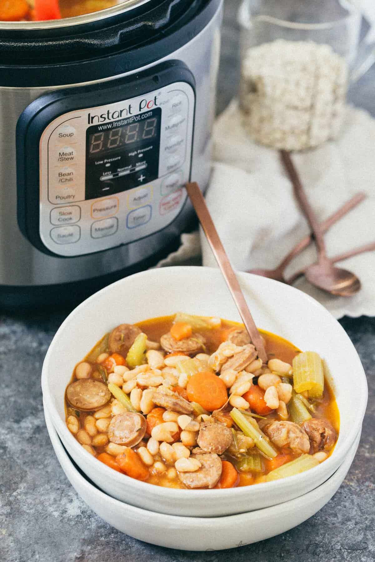 A deliciously flavorful herbed white bean and sausage soup that requires no beans to be soaked! This will be a new Instant Pot favorite!