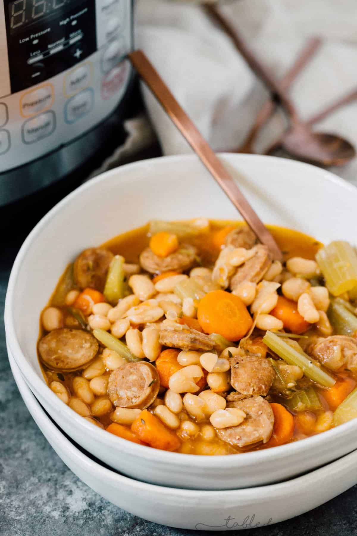 A deliciously flavorful herbed white bean and sausage soup that requires no beans to be soaked! This will be a new Instant Pot favorite!